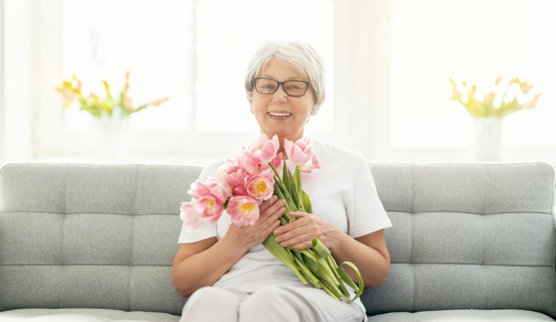 senior woman with pink flowers