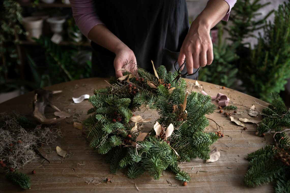 Woman making Christmas wreath of spruce, step by step.